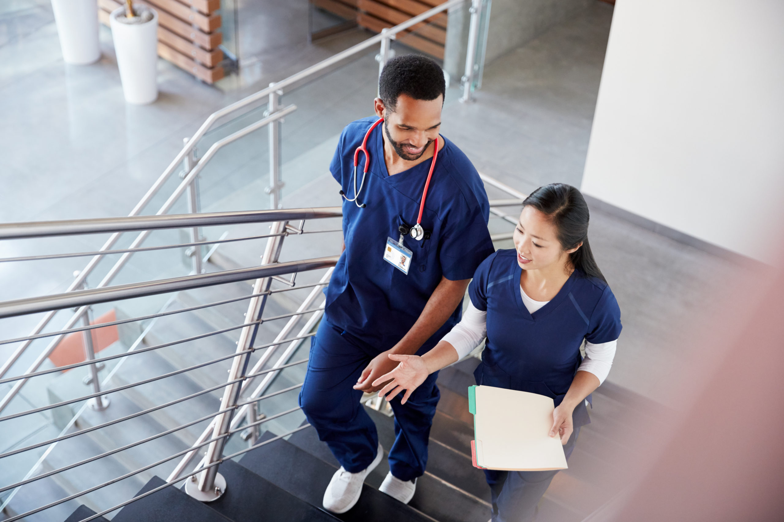 Two Healthcare Colleagues Talking on the stairs